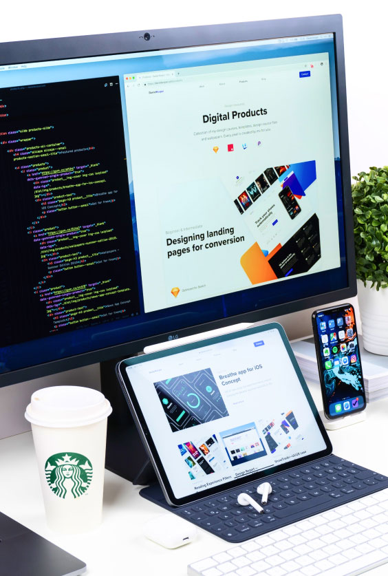 Workstation Setup 1 Desktop workspace with a large monitor showing code and a webpage, tablet with keyboard displaying designs, smartphone, AirPods, and coffee cup.